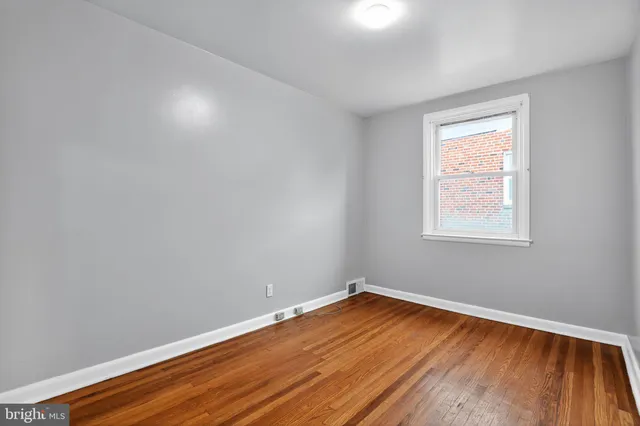 a view of a room with wooden floor and windows