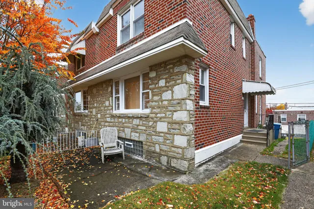 a front view of a house with wooden fence