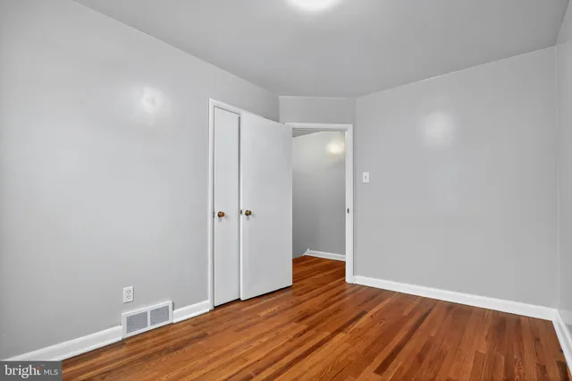 a view of room with wooden floor