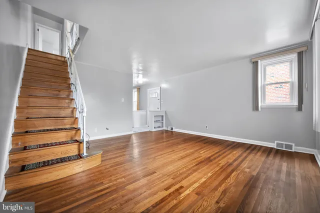 a view of wooden floor and windows in a room