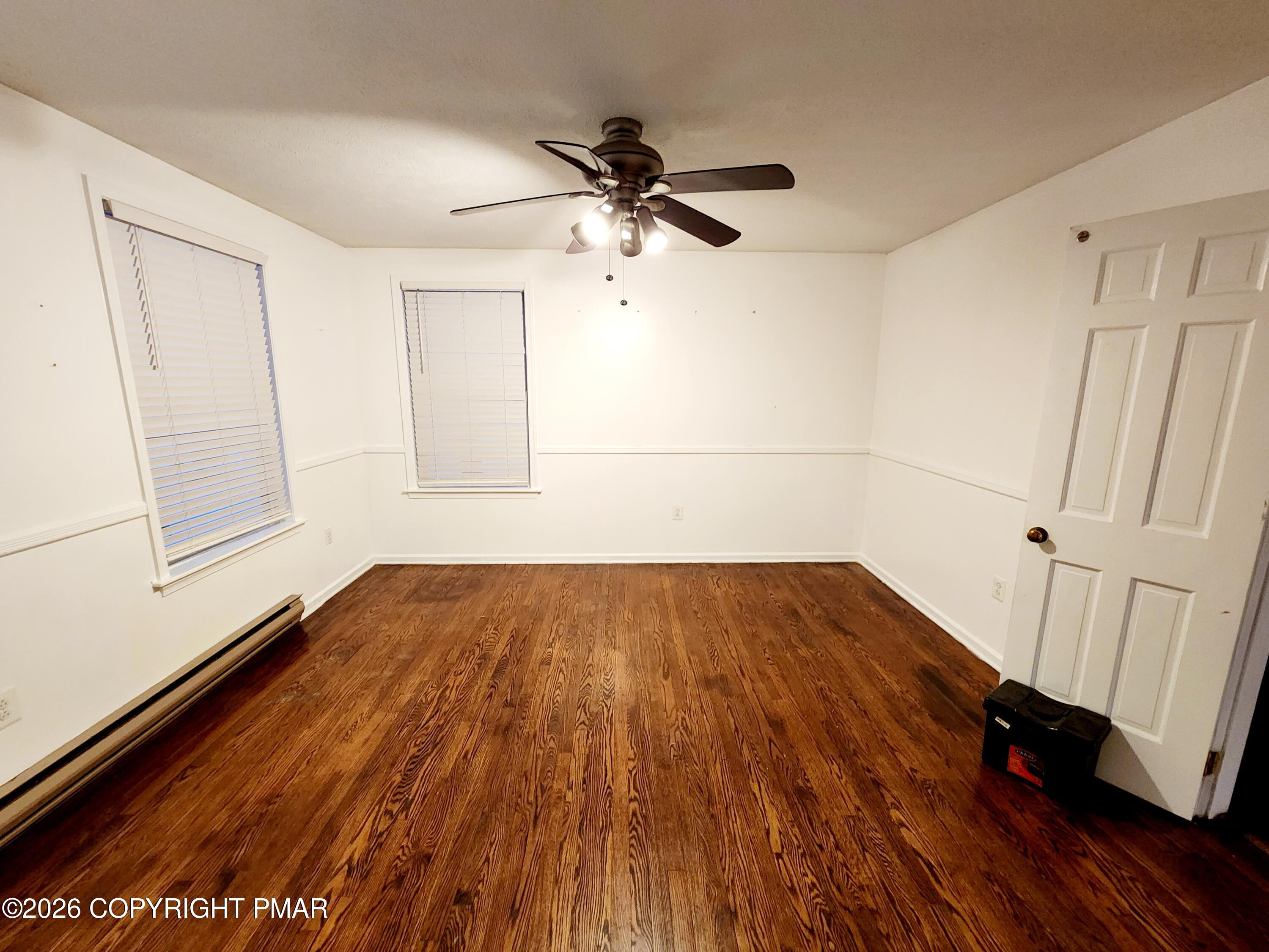 239 Rock Ridge Road Mount Pocono, PA 18344 - Photo 12 of 33 a view of an empty room with wooden floor and a window