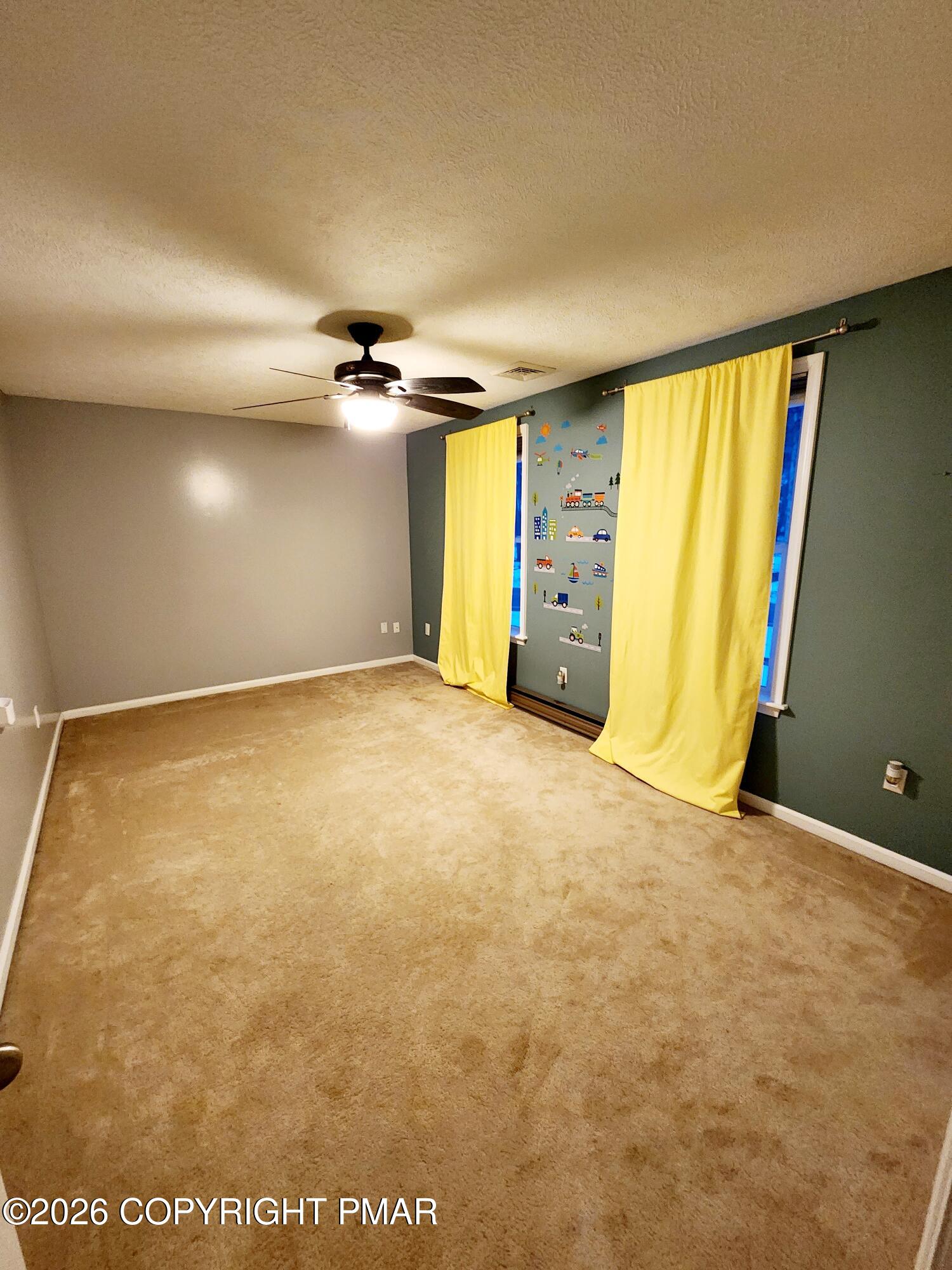 239 Rock Ridge Road Mount Pocono, PA 18344 - Photo 20 of 33 an empty room with a ceiling fan and window