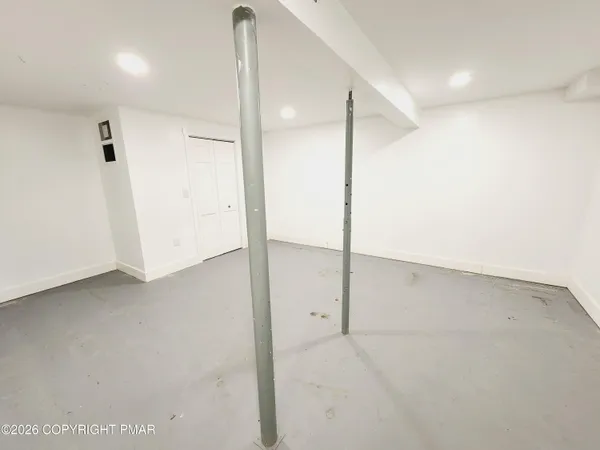 an empty room with a projector and wooden floor