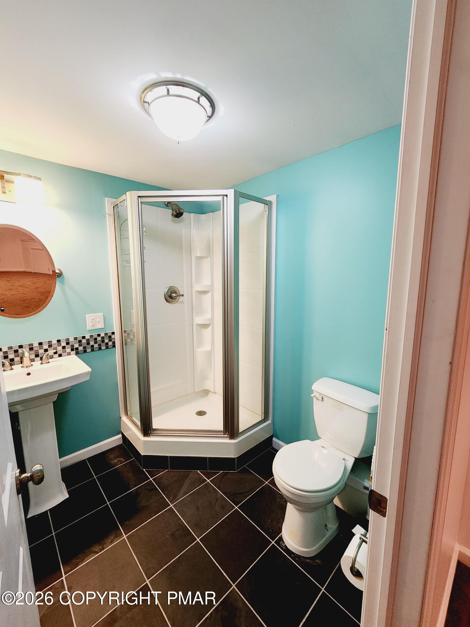 239 Rock Ridge Road Mount Pocono, PA 18344 - Photo 25 of 33 a bathroom with a toilet a sink and mirror