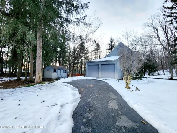 a view of a house with a snow in the road