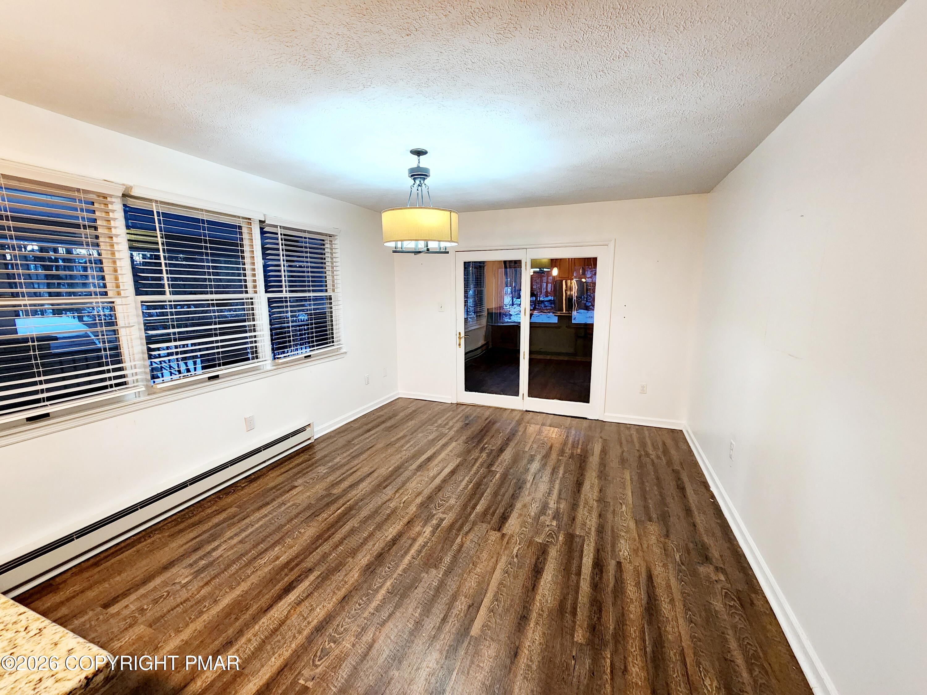 239 Rock Ridge Road Mount Pocono, PA 18344 - Photo 9 of 33 a view of empty room with wooden floor and fan