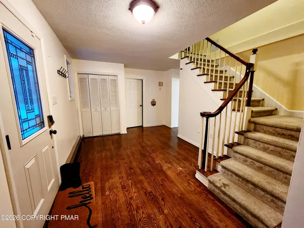 a view of a livingroom with wooden floor and stairs