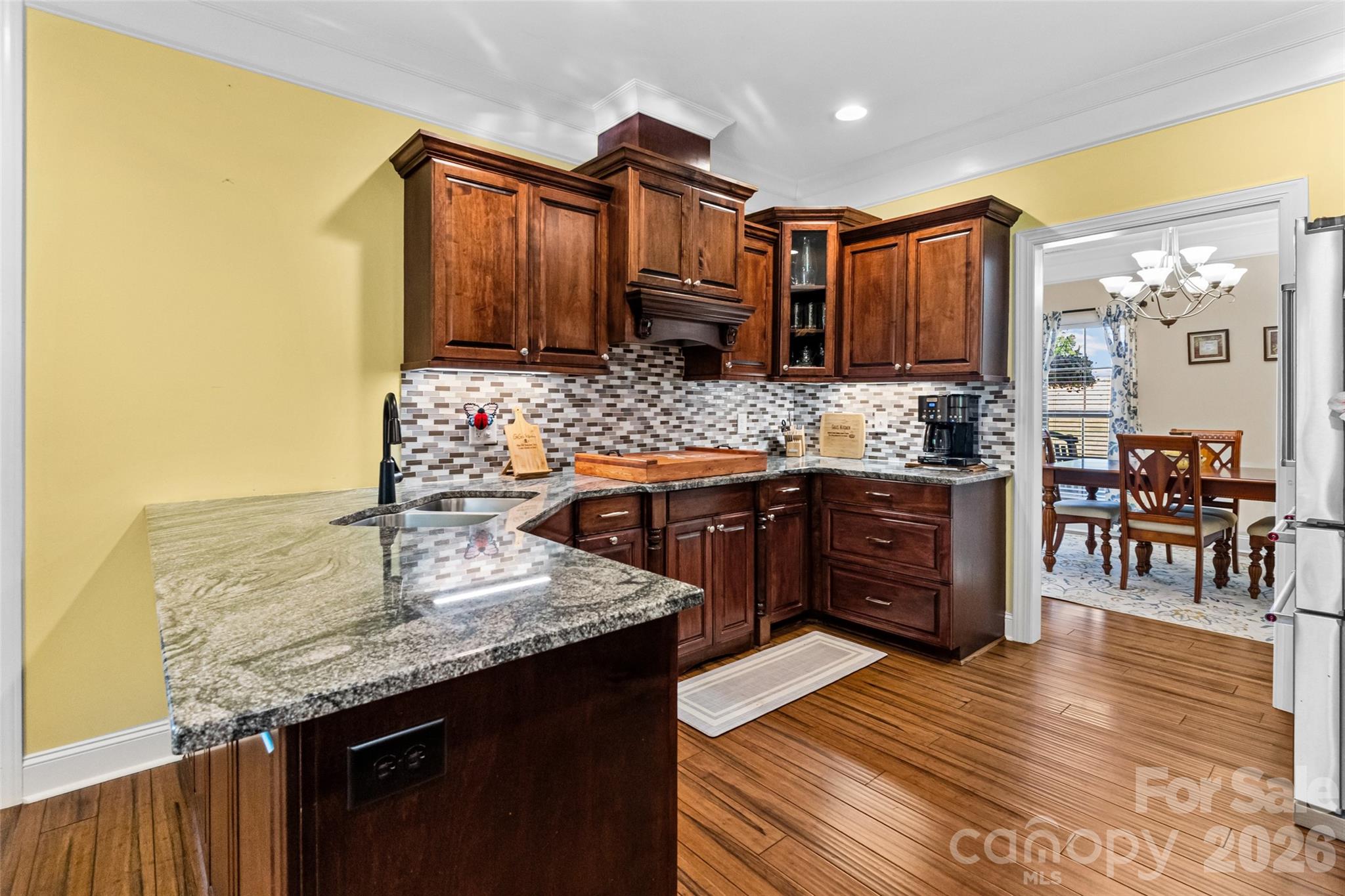 643 John Doster Road Pageland, SC 29728 - Photo 13 of 35 a kitchen with stainless steel appliances granite countertop a sink stove and wooden cabinets
