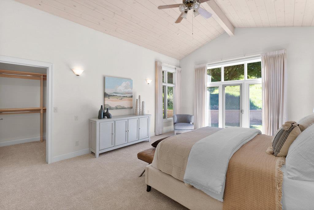 4575 Paul Sweet Road Soquel, CA 95073 - Photo 23 of 55 a spacious bedroom with a bed and a chandelier