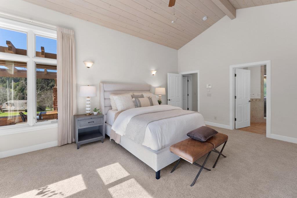 4575 Paul Sweet Road Soquel, CA 95073 - Photo 24 of 55 a spacious bedroom with a bed a table and a large window