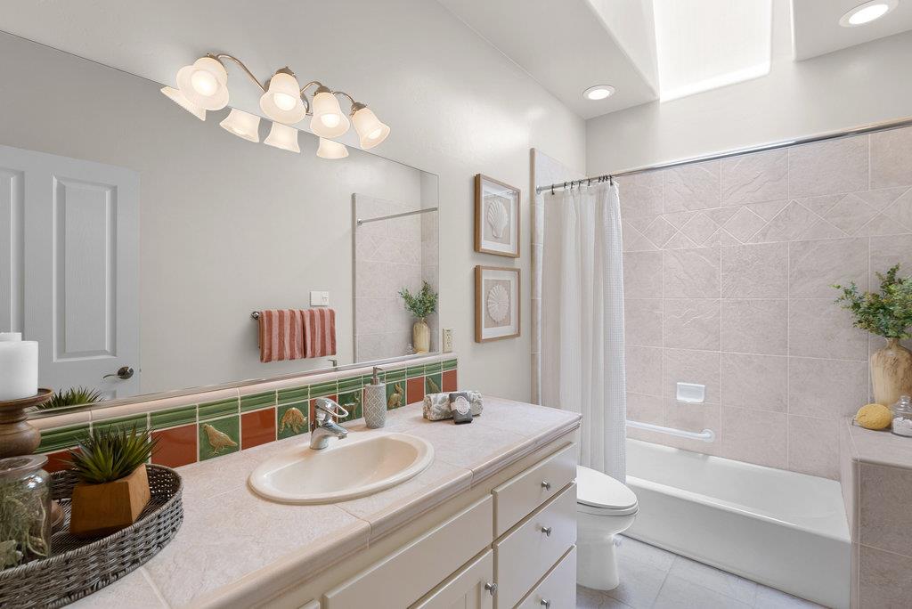 4575 Paul Sweet Road Soquel, CA 95073 - Photo 31 of 55 a bathroom with a granite countertop sink a toilet a mirror a vanity and shower