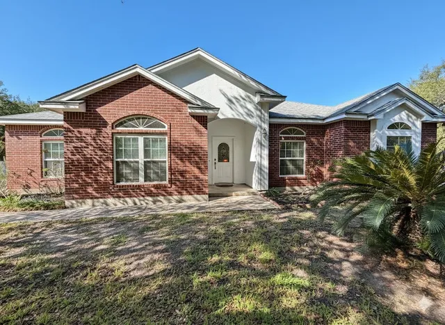 a front view of a house with a yard