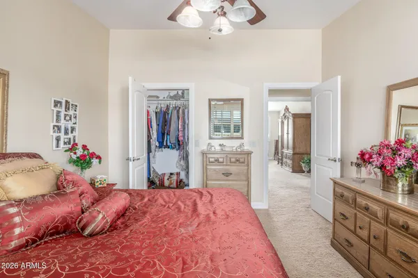 a bed room with a bed mirror and a dresser