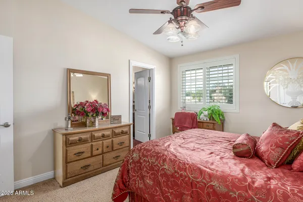 a bedroom with a bed and a dresser in it
