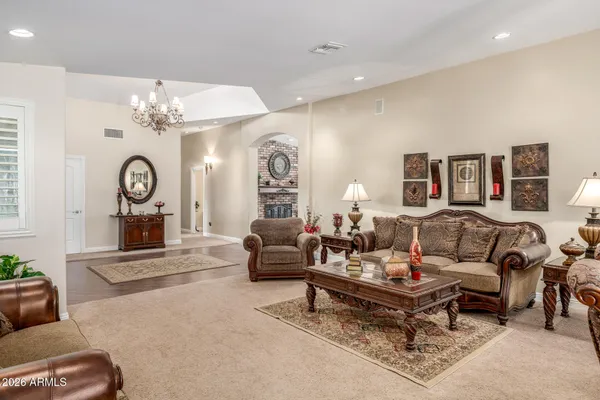 a living room with furniture a large window and a clock