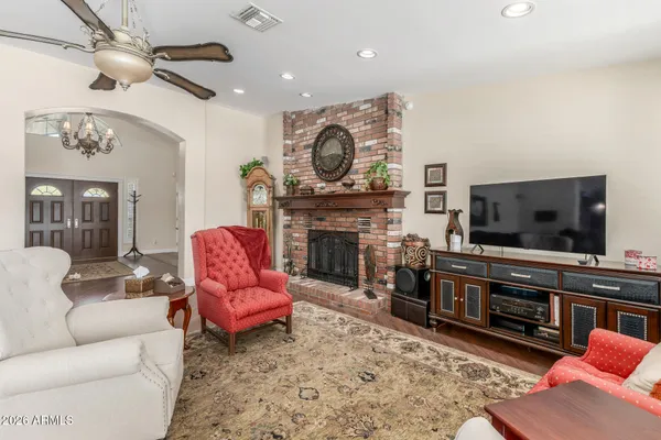 a living room with furniture a flat screen tv and a fireplace