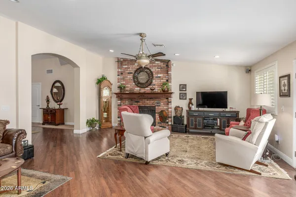 a living room with furniture a flat screen tv and a fireplace