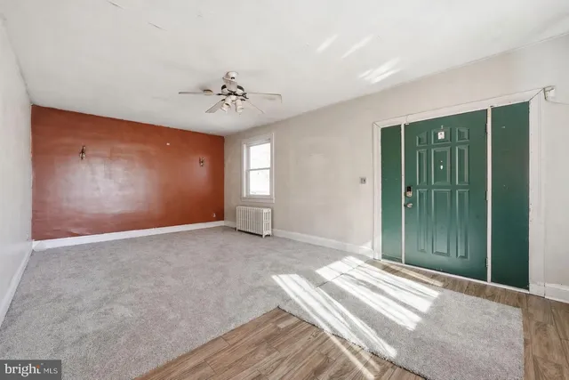 a view of a livingroom with a chandelier fan
