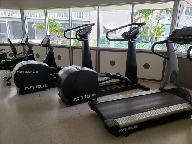 a room with gym equipment and large window