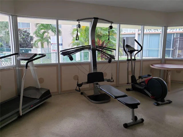 a room with gym equipment and a large window