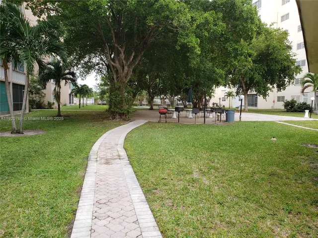 a view of a park with bench and trees