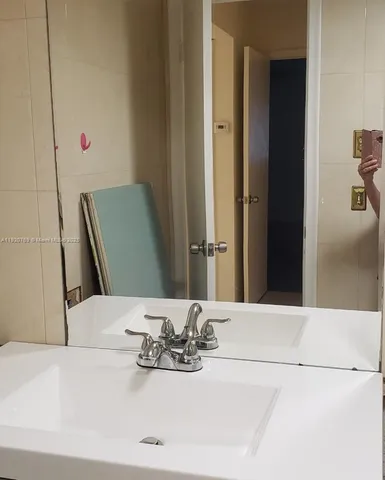 a bathroom with a sink and a mirror