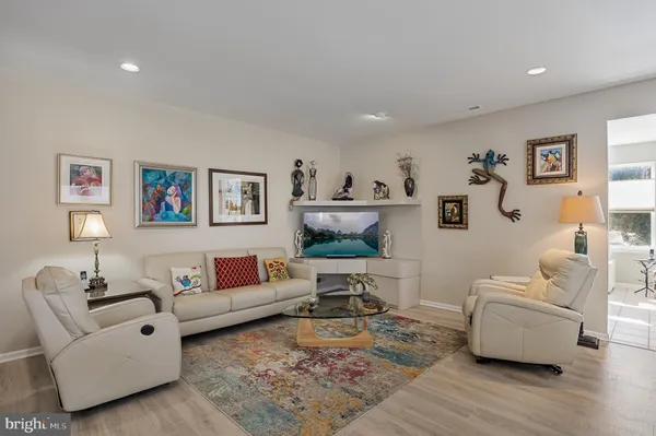 a living room with granite countertop furniture and a wooden floor
