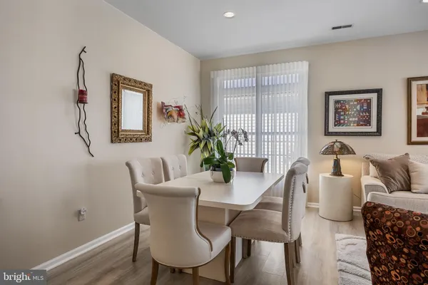 a dining room with furniture and wooden floor