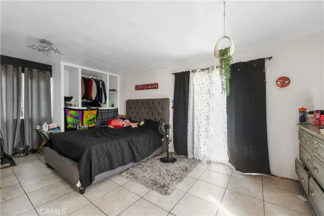 a bedroom with furniture and a flat screen tv