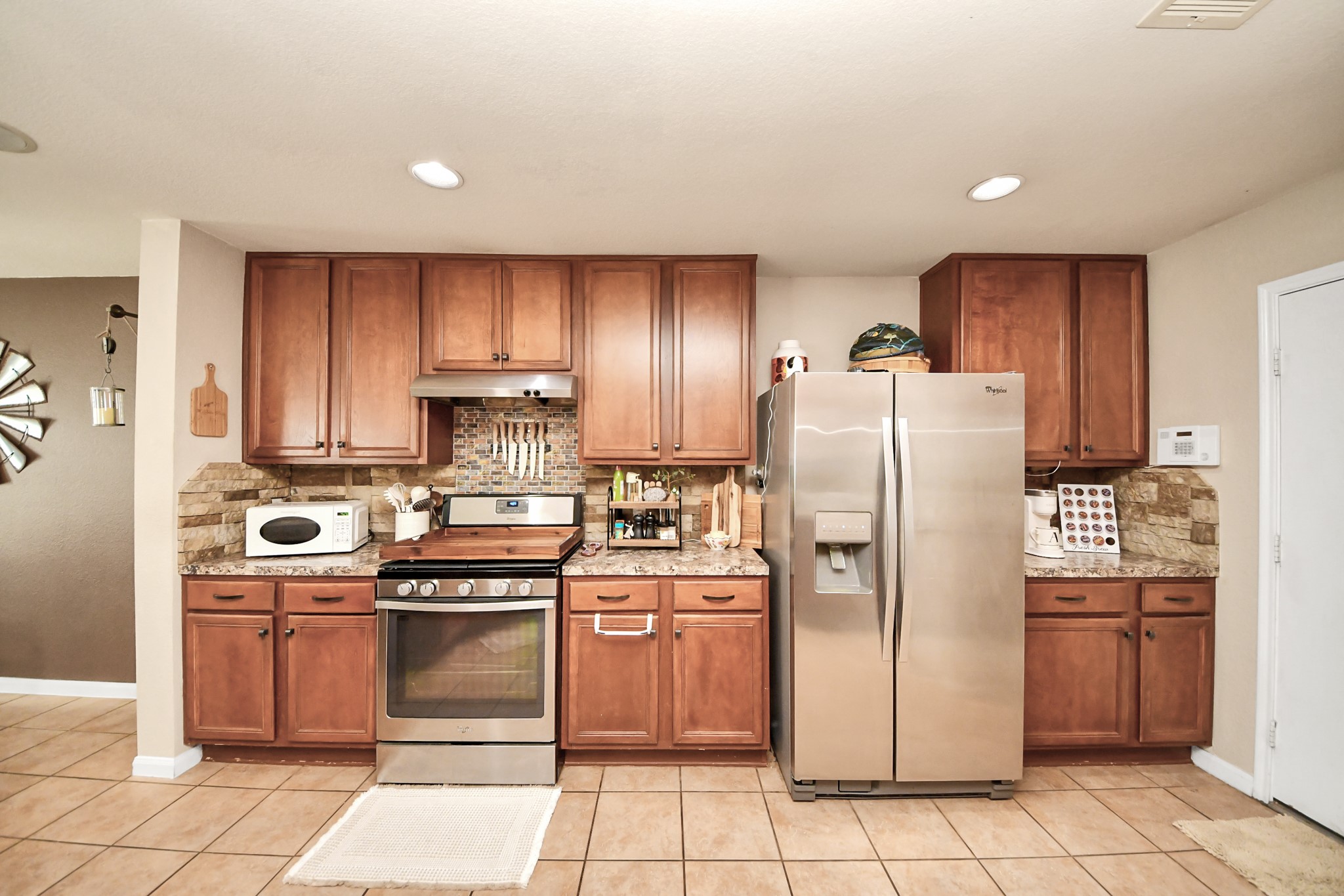 3007 Swift Brook Glen Way Spring, TX 77389 - Photo 15 of 32 Well designed kitchen featuring stainless steel appliances, rich cabinetry, ample counter space, and a functional layout for everyday living.