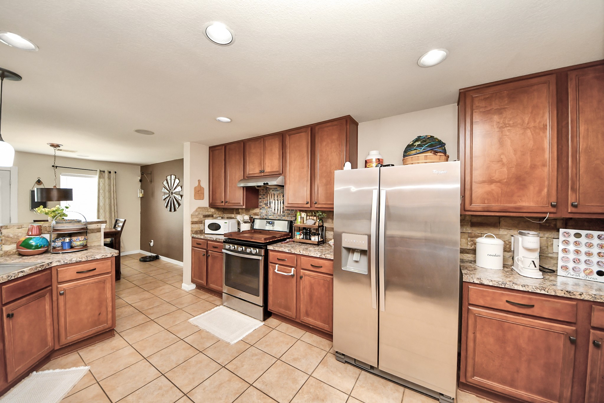3007 Swift Brook Glen Way Spring, TX 77389 - Photo 4 of 32 Spacious kitchen featuring stainless steel appliances, abundant cabinetry, and plenty of counter space for cooking and entertaining.