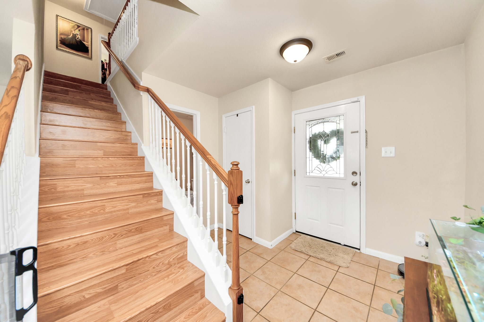 3007 Swift Brook Glen Way Spring, TX 77389 - Photo 9 of 32 As you enter the home, you are welcomed by a functional layout featuring a coat closet near the entrance, a powder bath, and additional storage space tucked underneath the staircase.