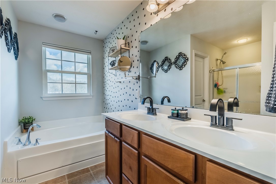 6687 List Street Northwest Canton, OH 44708 - Photo 17 of 21 Full bathroom with double vanity, a garden tub, and a shower stall