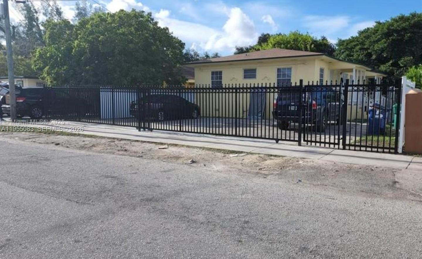 2729 Northwest 47th Street Miami, FL 33142 - Photo 1 of 34 a view of a house with wooden fence next to a yard