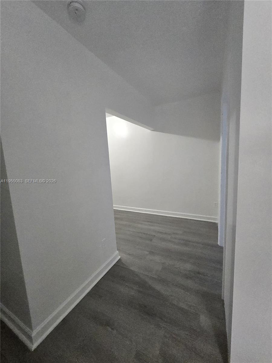 2729 Northwest 47th Street Miami, FL 33142 - Photo 11 of 34 an empty room with wooden floor