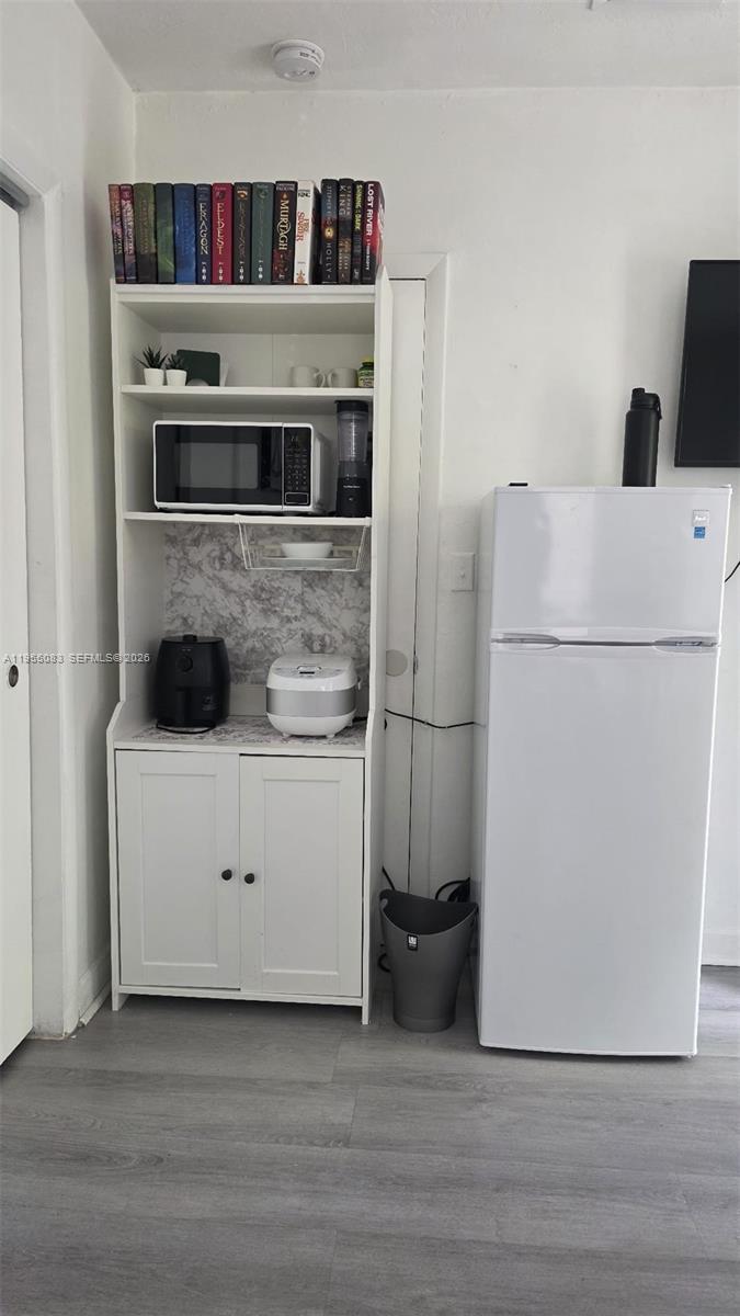 2729 Northwest 47th Street Miami, FL 33142 - Photo 16 of 34 a kitchen with stainless steel appliances a refrigerator and a stove