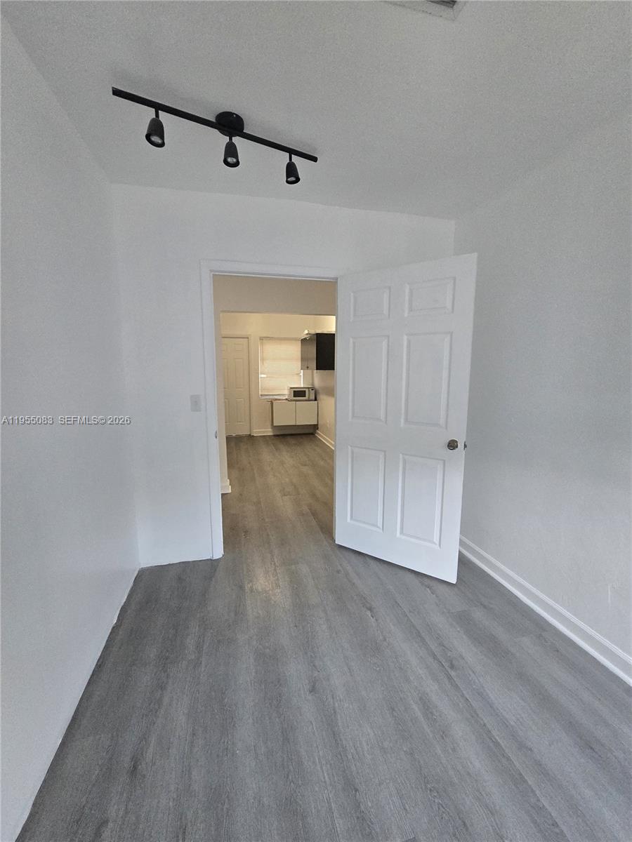 2729 Northwest 47th Street Miami, FL 33142 - Photo 2 of 34 a view of a room with wooden floor and a ceiling fan