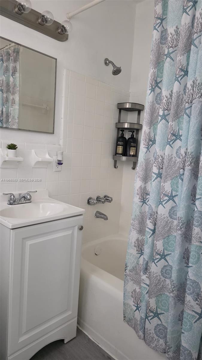 2729 Northwest 47th Street Miami, FL 33142 - Photo 21 of 34 a bathroom with a sink a vanity and a bathtub