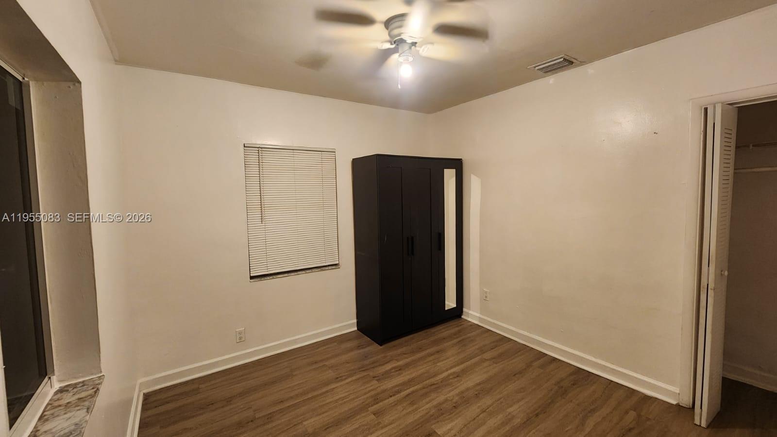 2729 Northwest 47th Street Miami, FL 33142 - Photo 32 of 34 an empty room with wooden floor and hallway