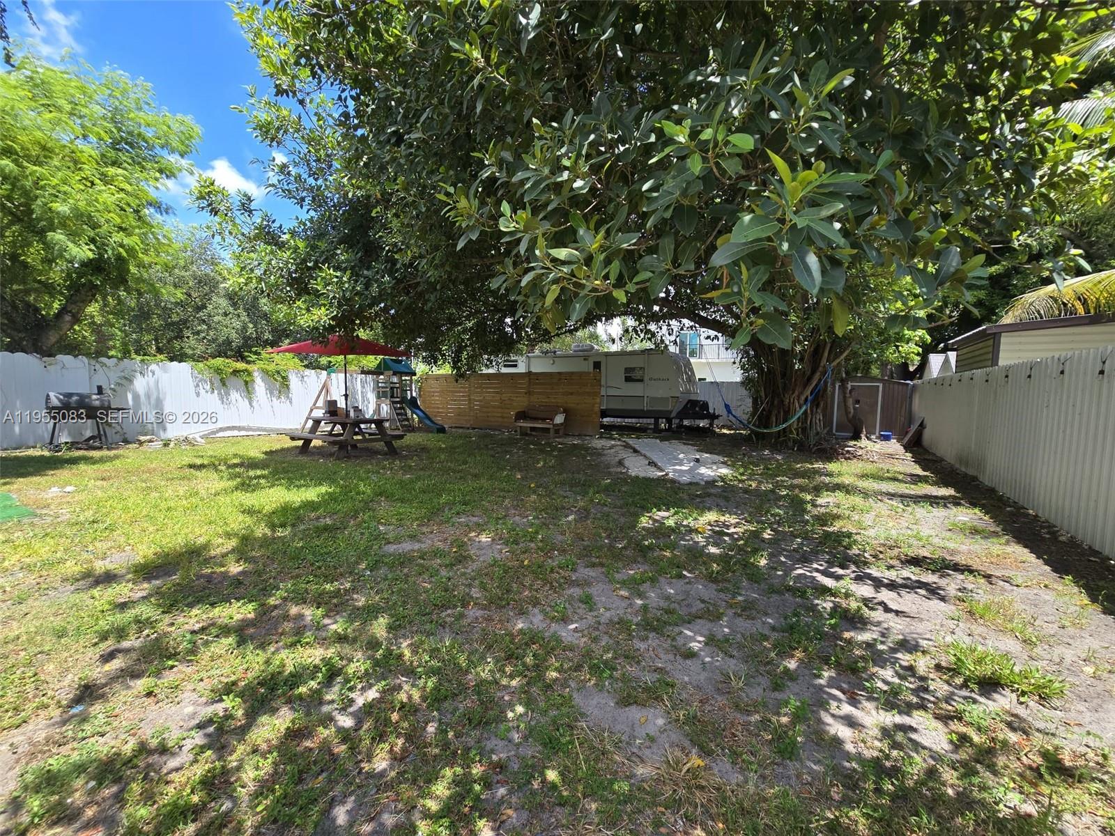 2729 Northwest 47th Street Miami, FL 33142 - Photo 33 of 34 a view of a backyard with large trees