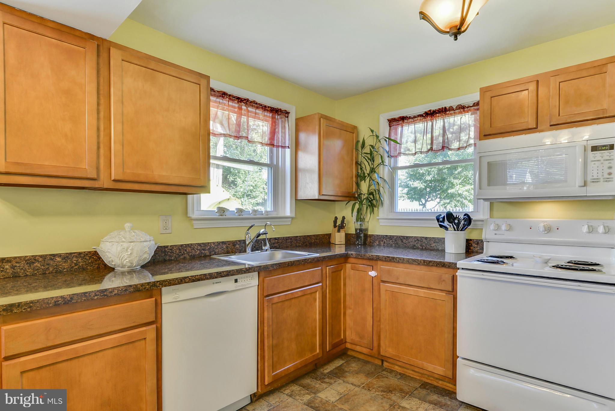 2707 Weisman Road Silver Spring, MD 20902 - Photo 11 of 30 a kitchen with stainless steel appliances granite countertop a sink stove and cabinets