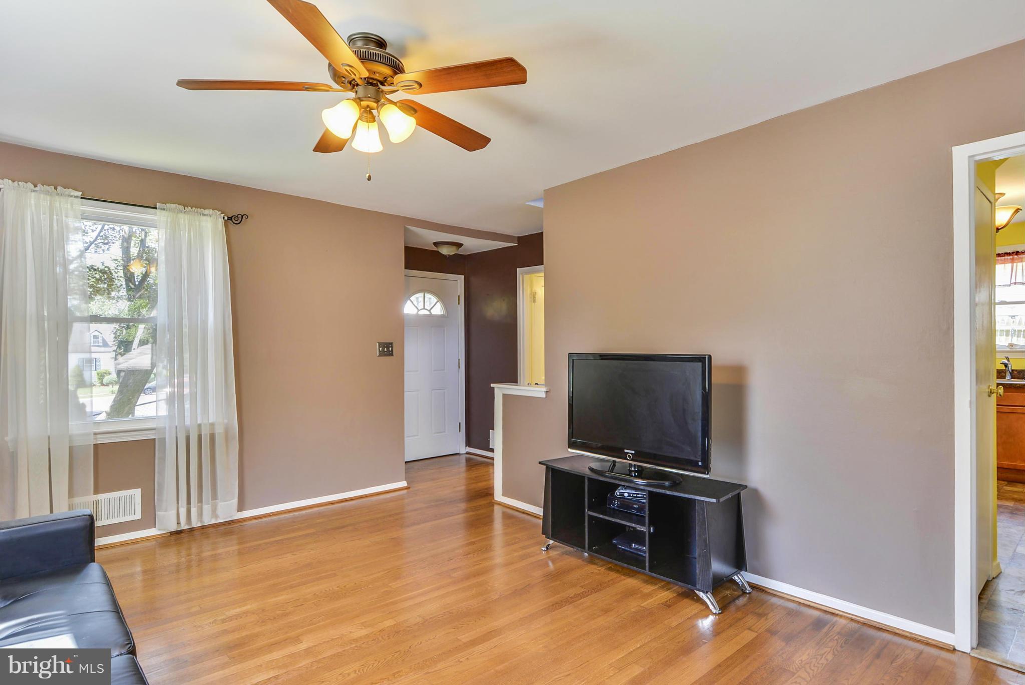 2707 Weisman Road Silver Spring, MD 20902 - Photo 14 of 30 a living room with a flat screen tv and a window