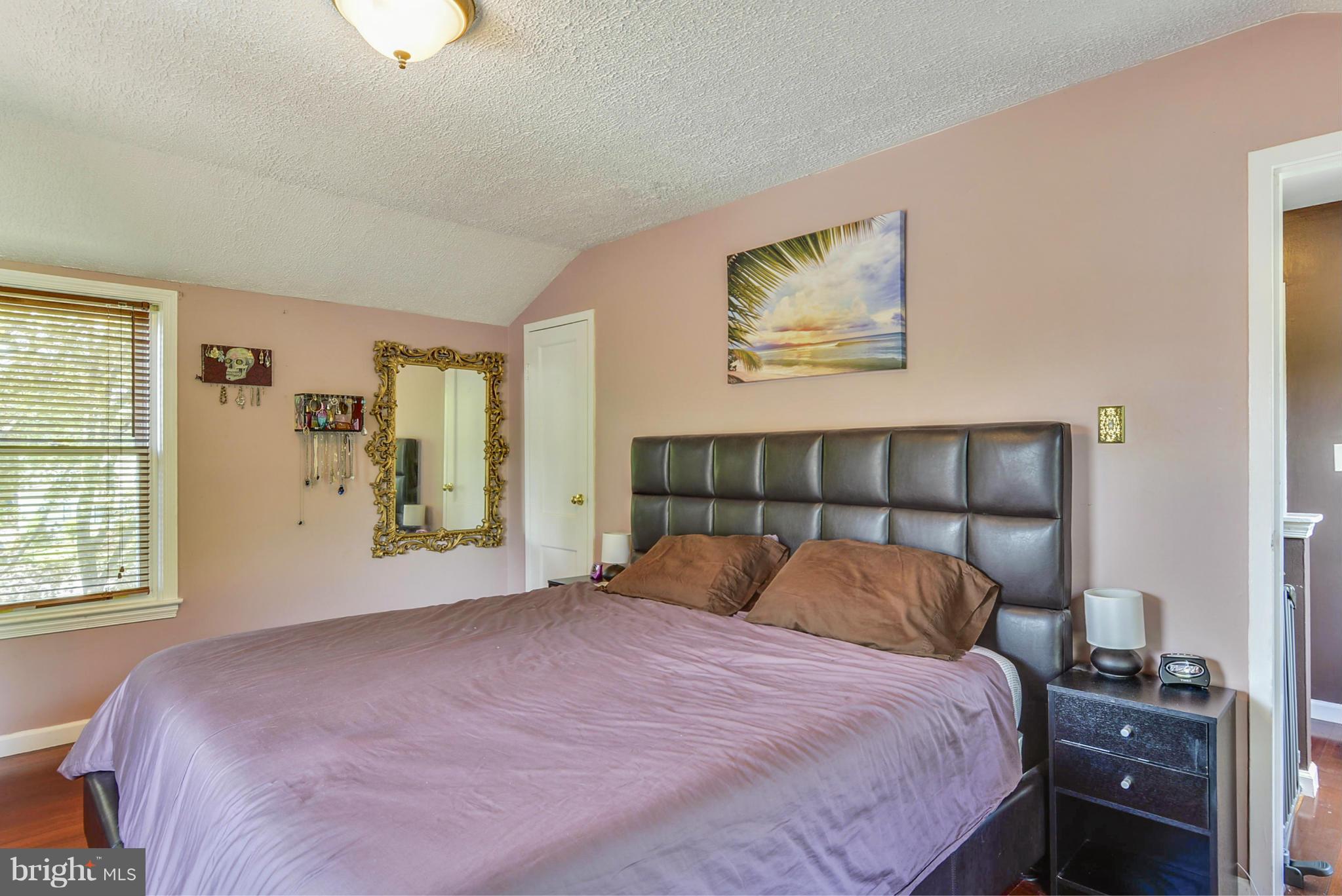 2707 Weisman Road Silver Spring, MD 20902 - Photo 18 of 30 a bedroom with a bed and wooden floor