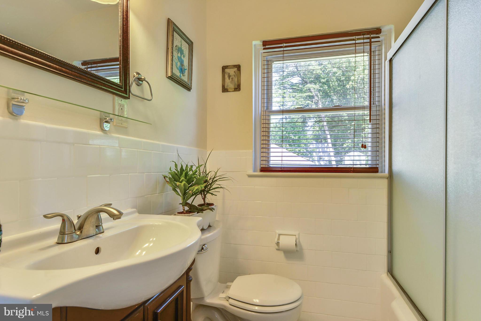 2707 Weisman Road Silver Spring, MD 20902 - Photo 22 of 30 a bathroom with a sink a toilet and shower