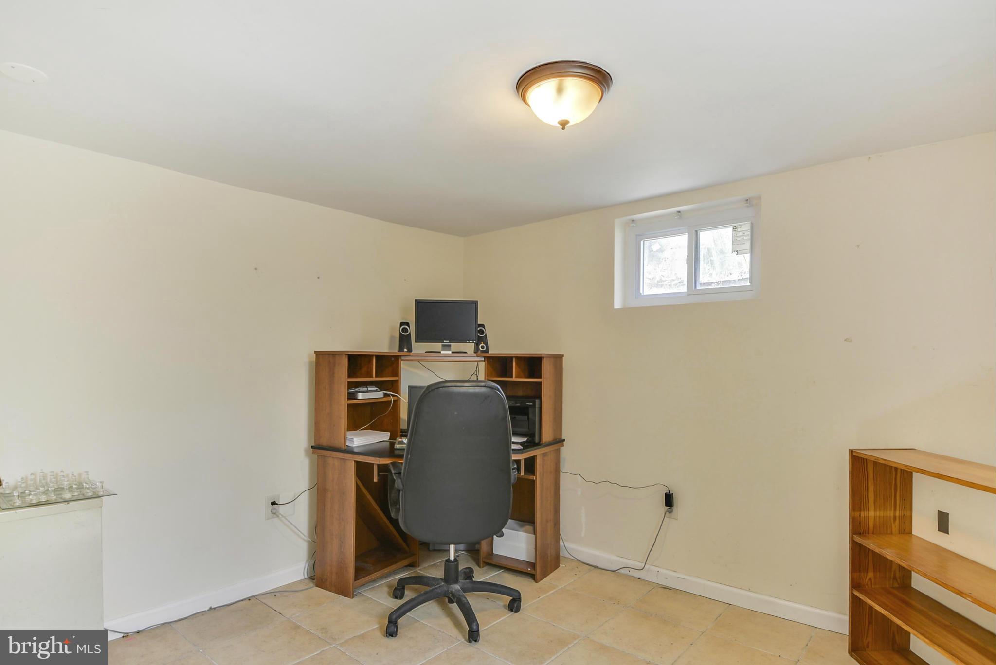 2707 Weisman Road Silver Spring, MD 20902 - Photo 24 of 30 a view of a workspace with furniture and a window
