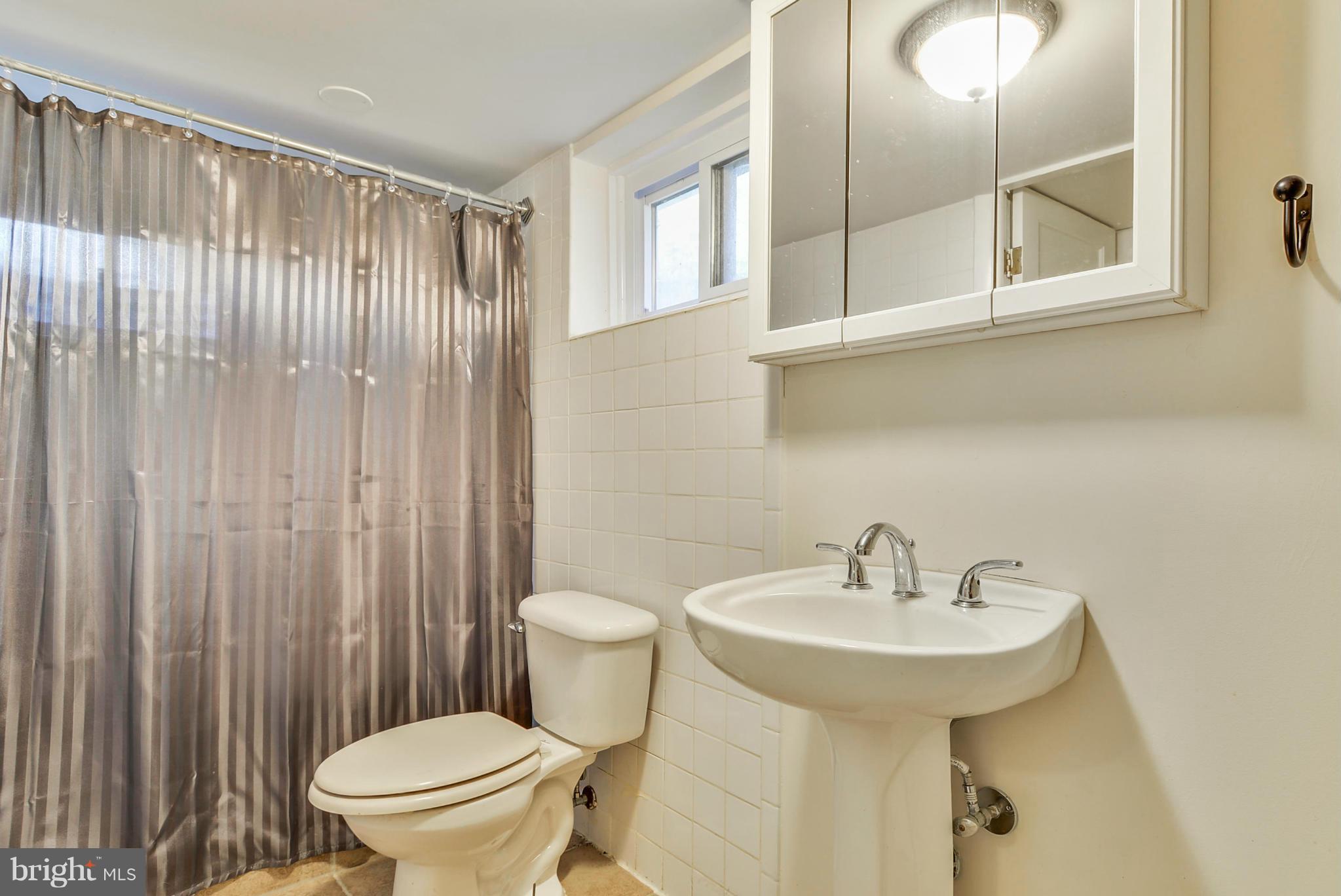 2707 Weisman Road Silver Spring, MD 20902 - Photo 26 of 30 a bathroom with a sink a toilet and shower