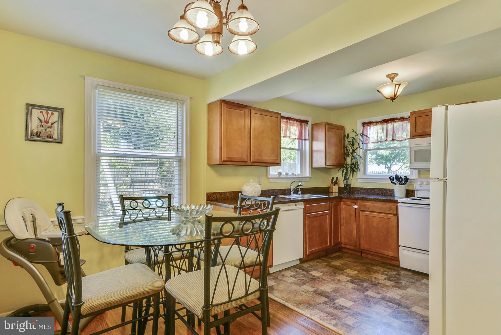2707 Weisman Road Silver Spring, MD 20902 - Photo 9 of 30 a kitchen with cabinets and chairs