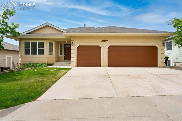 12124 Stanley Canyon Road Colorado Springs, CO 80921 - Photo 3 of 34 Single story home featuring a garage and a front yard