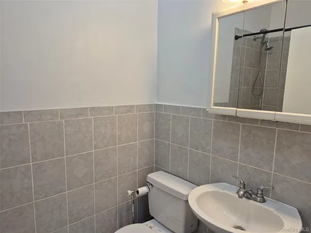 a bathroom with a toilet sink and shower