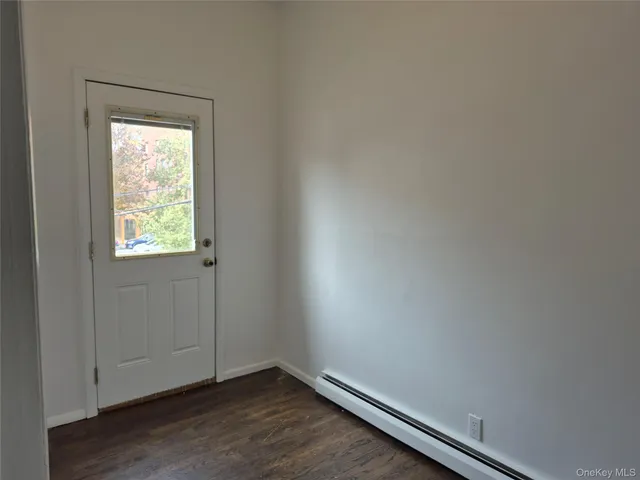 a view of an empty room and wooden floor